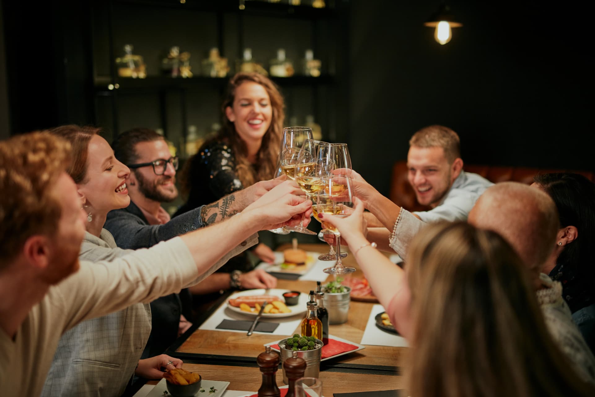 Couples raising their glasses together over dinner