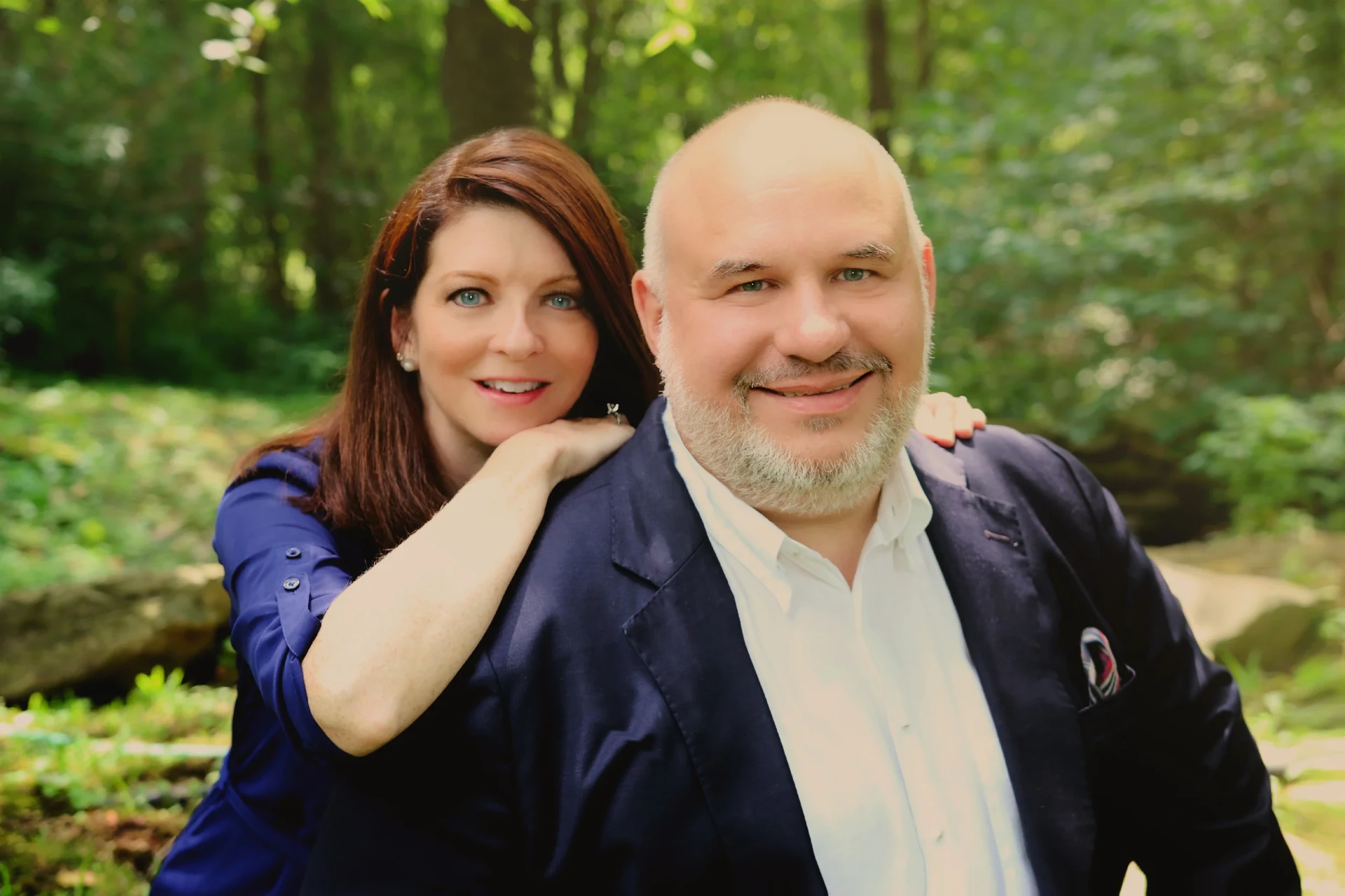 Dr. Greg and Lisa Popcak smiling together outdoors